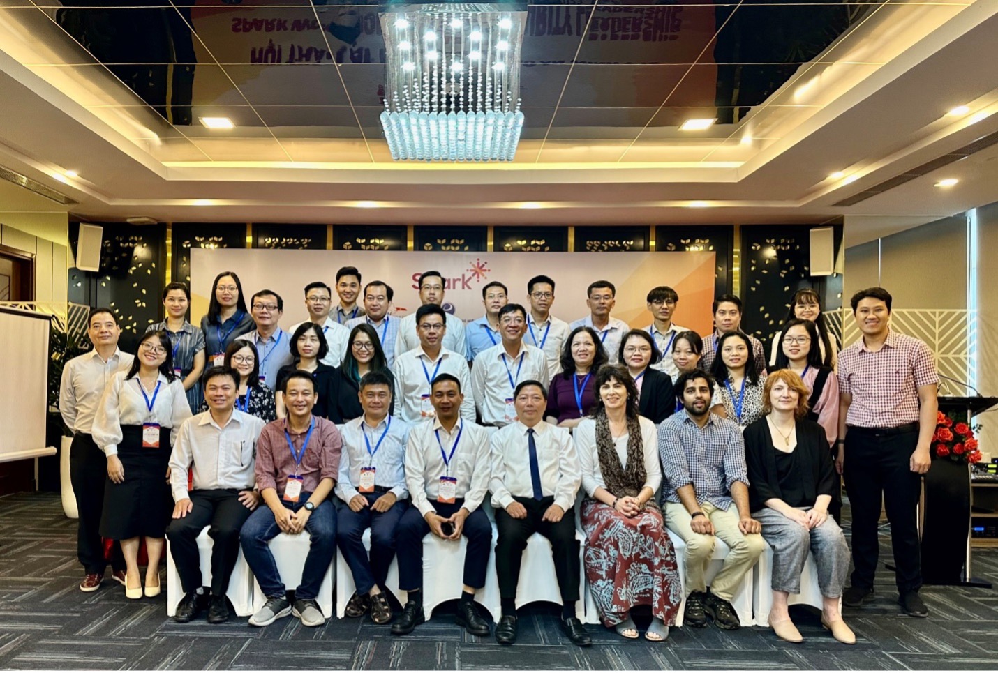 Photograph showing participants of the workshop in Vietnam. Participants are in three rows, with approximately 40 people in the photo.